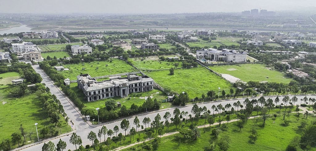 a drone shot of gulberg showing greenry and houses.
